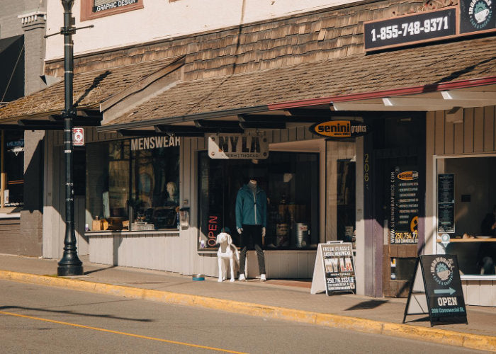 NYLA Fresh Thread's Nanaimo storefront with signage, mannequin and dog on display