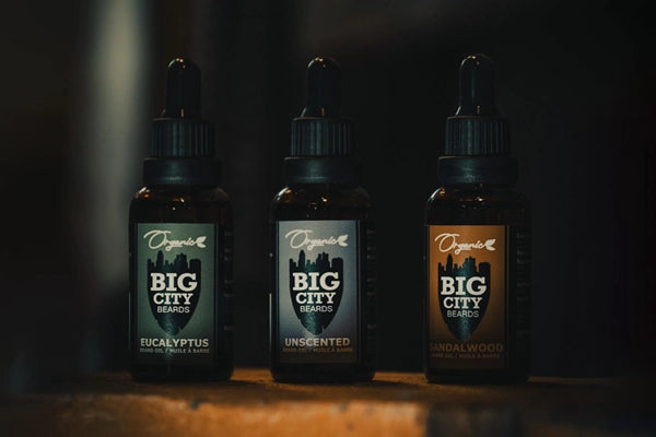 Eucalyptus, unscented and sandal wood Big City Beard oils displayed in a line