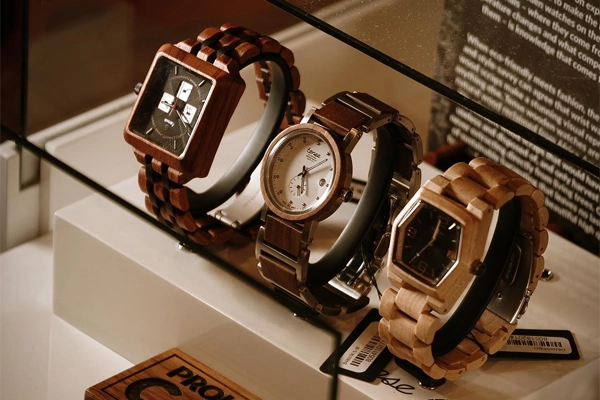 Three Tense wooden watches displayed in case at NYLA Fresh Thread's Nanaimo store