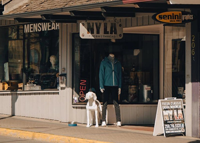 NYLA Fresh Thread's Nanaimo storefront with signage, mannequin and dog on display